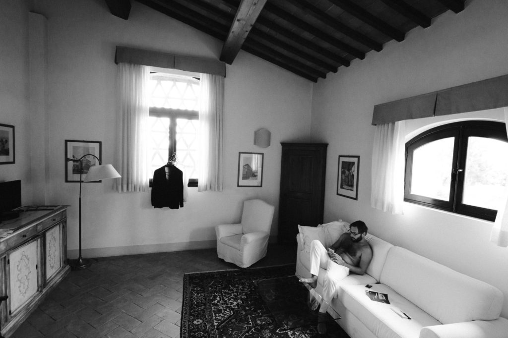 French wedding photographer: the groom kills time in his room, waiting for the day to start